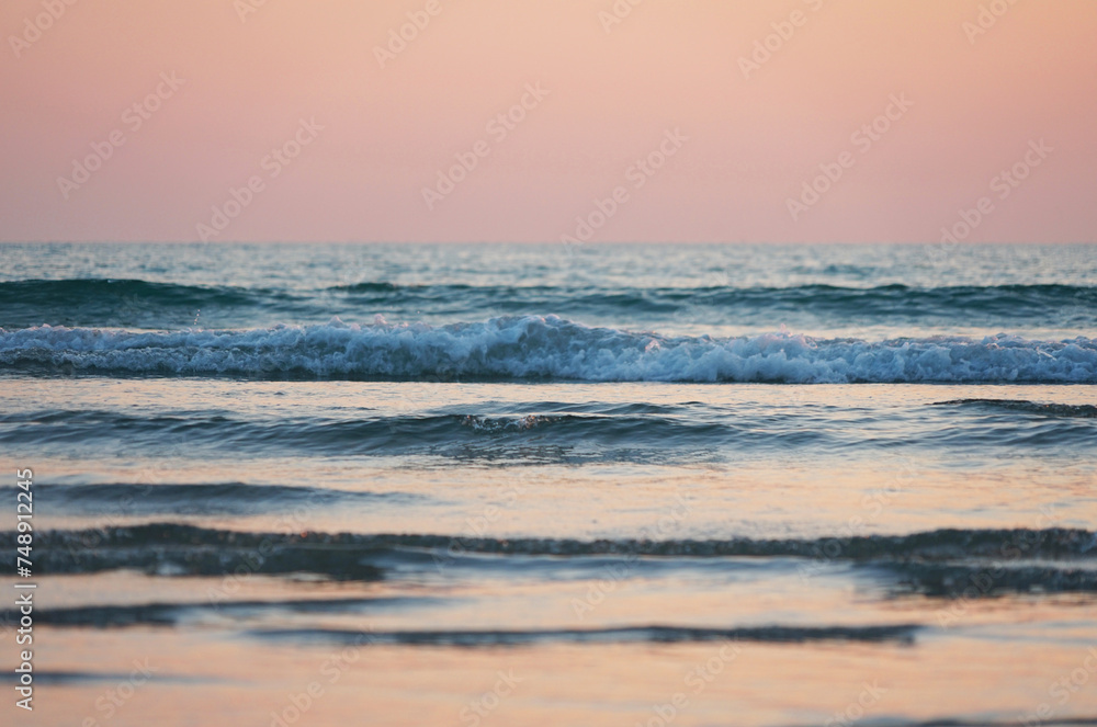 Fototapeta premium Beach and waves at sunset