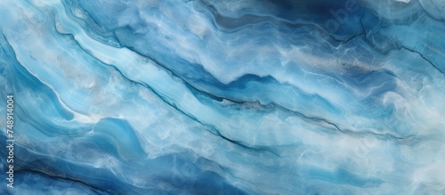 A painting depicting blue and white waves flowing on a white background. The brushstrokes create a sense of movement and rhythm, capturing the dynamic nature of the ocean waves.