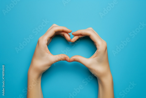 Hands making heart shape isolated on a red background - Love and minimal fashion concept
