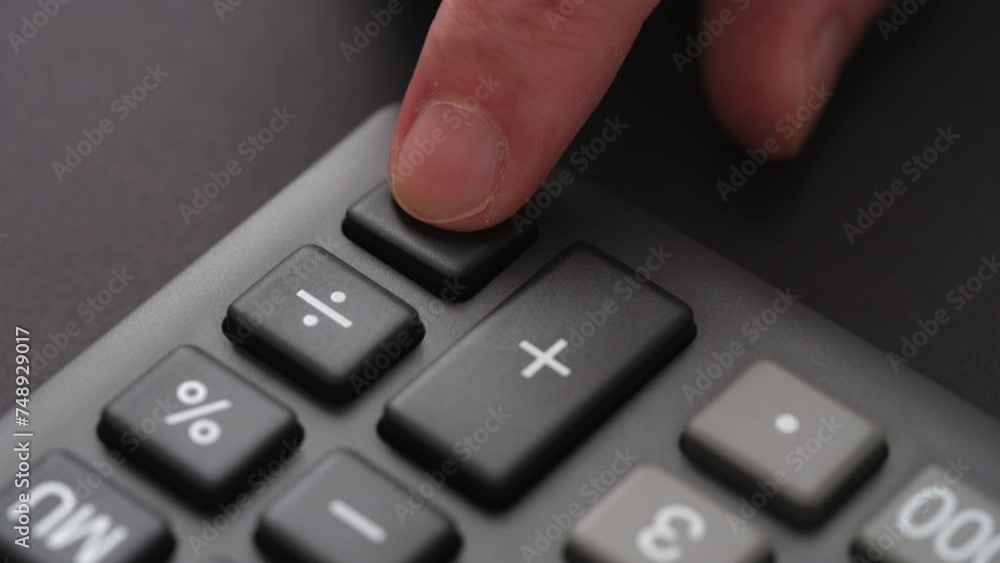 A man pressing the equals button on a calculator with his pointer finger. Close up.