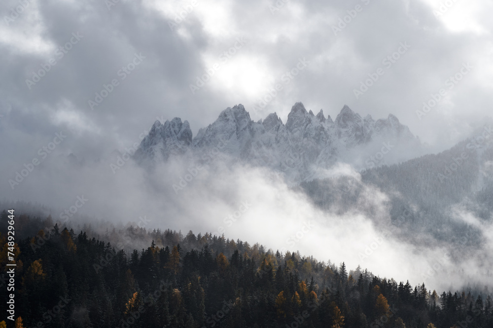 Fototapeta premium A moody scene in the Dolomites, with distant mountains surrounded by a blanket of thick clouds