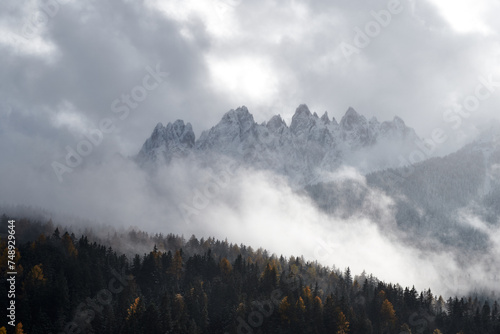 A moody scene in the Dolomites, with distant mountains surrounded by a blanket of thick clouds