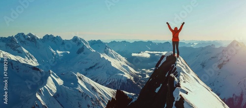 man on mountain top over sky and sun background