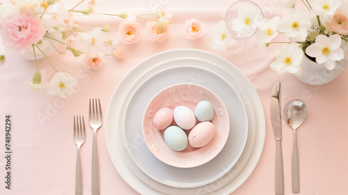 Beautiful Pastel table setting with eggs and spring flowers for Easter celebration.