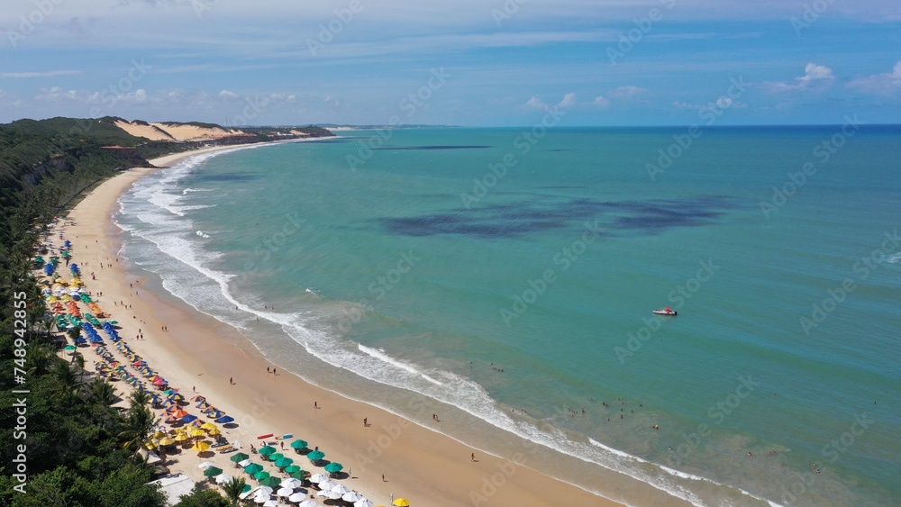 Aerial view of the calm and relaxing Madero beach with a private bay to swim with dolphins. Madero Beach, Natal, Rio Grande do Norte State in Brazil 