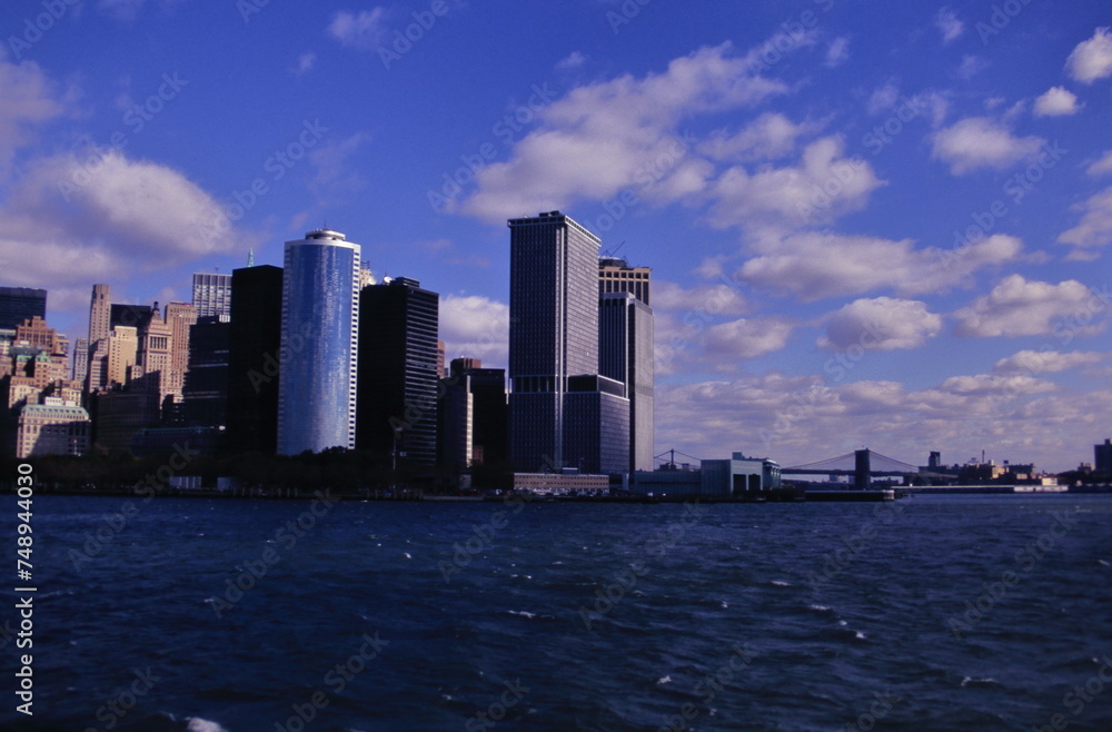 skyline of Manhattan and the East River under blue sky during early 1990s