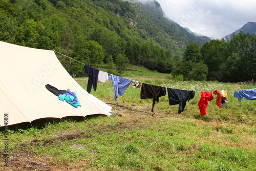 clothes hanging out to dry in the sun near the tent at a boys scout campsite photo