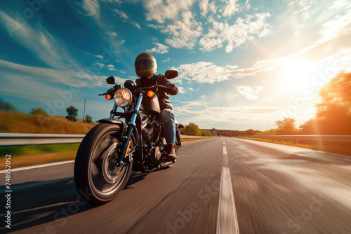 A man riding a motorcycle on a highway with a helmet and sunglasses