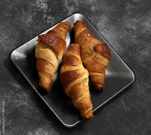 Freshly baked croissants, isolated on white background. 