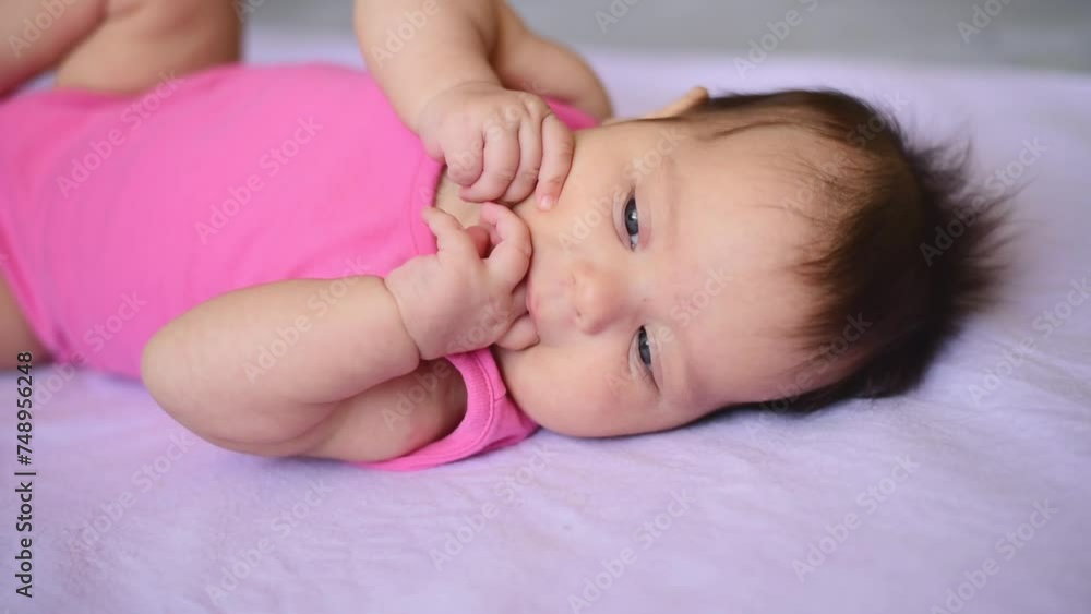 A newborn baby lying on blanket. Infant lying on purple blanket or cover. A newborn baby lying on blanket. Infant lying on purple blanket or cover.