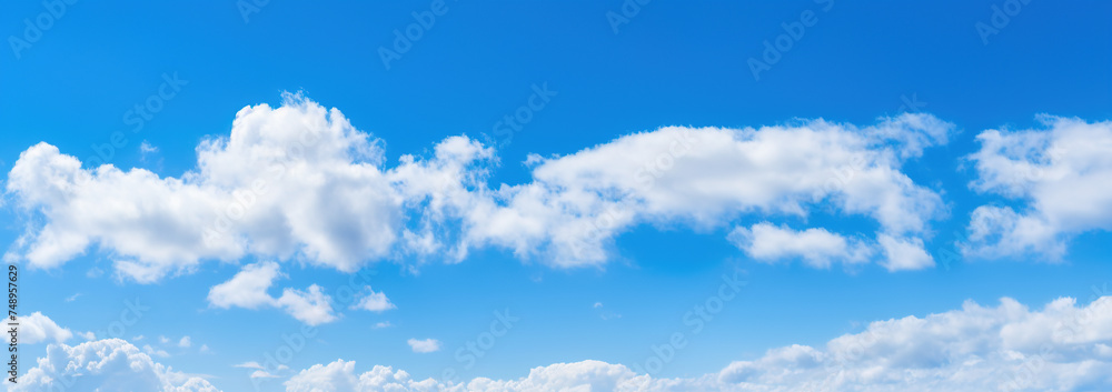 Fototapeta premium Scenic and Beautiful Bright blue sky with puffy clouds on a clear sunny day