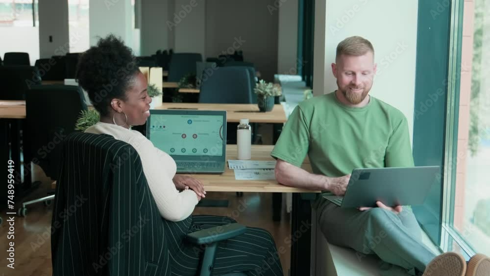 Two colleagues talking while working at office Two colleagues talking while working at office