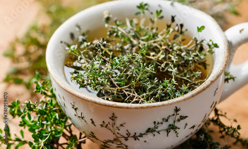 tea with thyme in a cup. Selective focus.