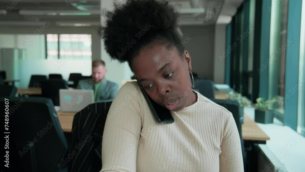 Black female consultant talking with client on smartphone