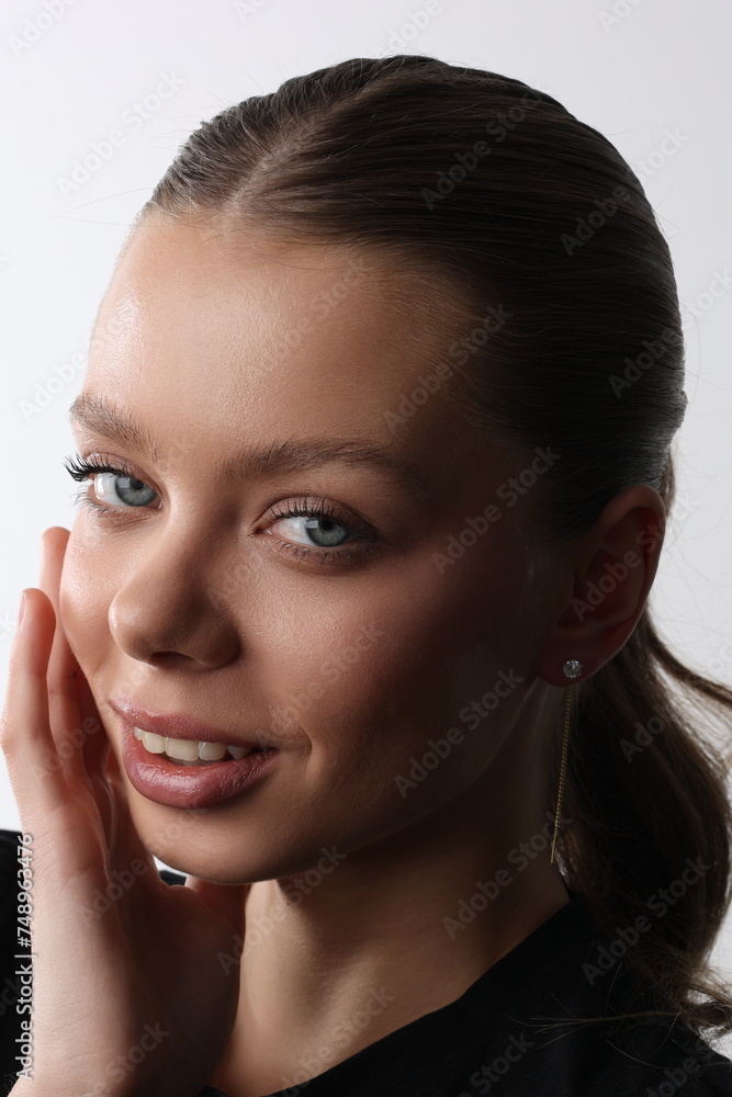 Beautiful young girl with fresh healthy skin. Woman advertise ear-rings. White background. Earrings closeup. Blond european woman with long hair with big lips, pretty smile. Cosmetology, scincare Beautiful young girl with fresh healthy skin. Woman advertise ear-rings. White background. Earrings closeup. Blond european woman with long hair with big lips, pretty smile. Cosmetology, scincare