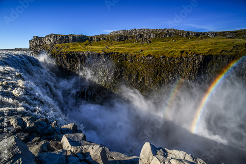 A rainbow on the spray of powerful Dettifoss waterfall, Jökulsárgljúfur Canyon, Vatnajökull National Park, Iceland.