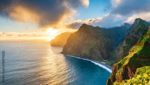 madeira island dramatic sunrise over atlantic ocean with waterfall landscape from miradouro do veu da noiva photo