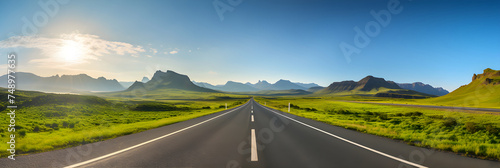 Open Road Adventure: An Inviting Asphalt Road to The Horizon Between Mountains and Blue Sky