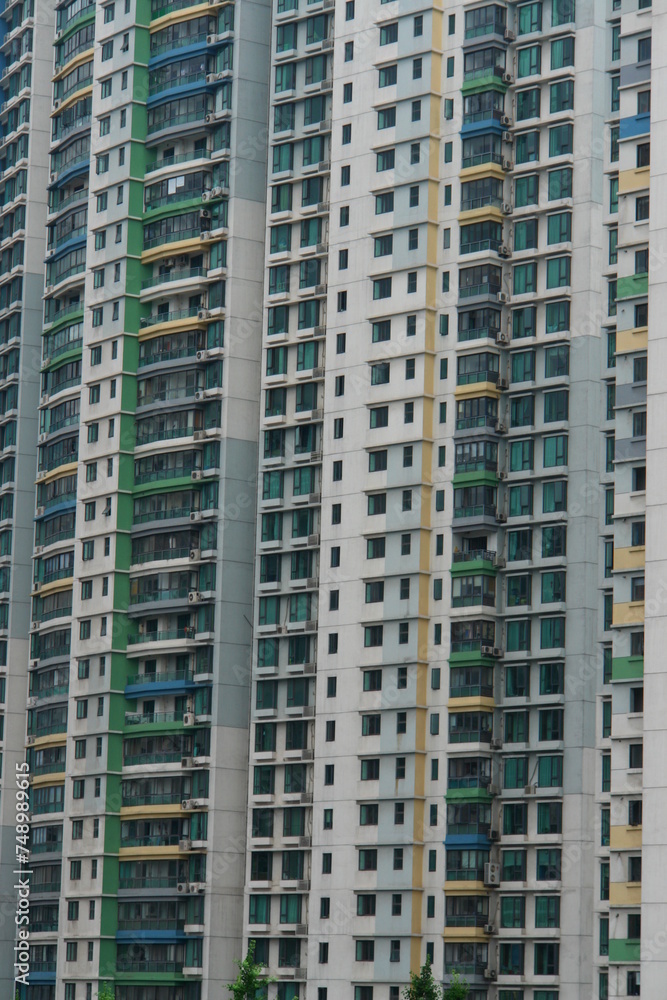 A tall building with many windows and a green stripe