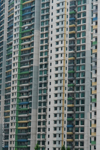 A tall building with many windows and a green stripe
