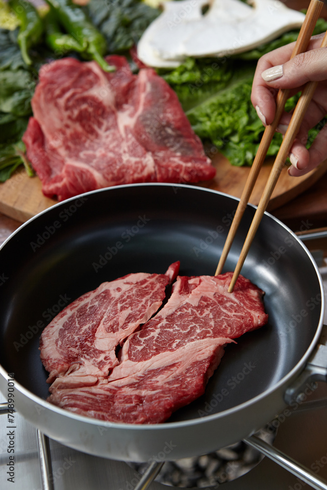raw meat on a frying pan raw meat on a frying pan