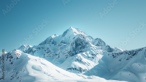 mountain peak, with snow-capped slopes and a clear blue sky, emphasizing the grandeur