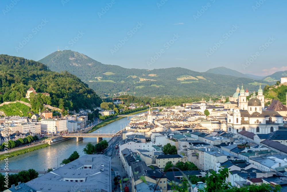 Panoramic View of Salzburg Cityscape with Alpine Backdrop in Sunset