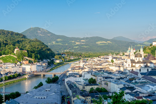 Panoramic View of Salzburg Cityscape with Alpine Backdrop in Sunset photo