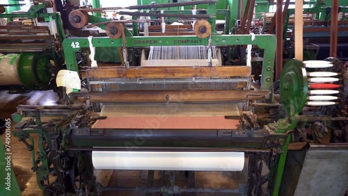 Lowell, Massachusetts: Lowell National Historical Park celebrates era of textile manufacturing during the Industrial Revolution. Boott Cotton Mills Museum recreated weave room. Weaving machine bobbin. photo