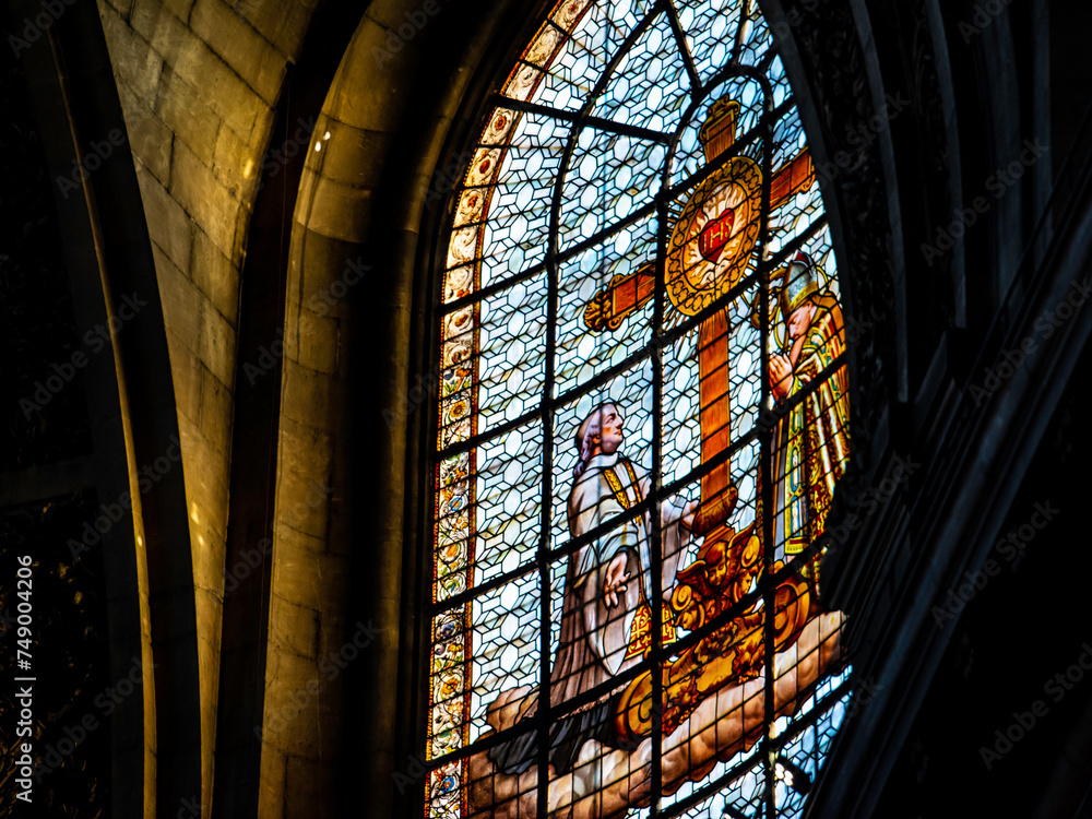 Paris, France - Dec. 27 2022: Stained glass window shaded in sunlight in St-Sulpice Cathedral in Paris