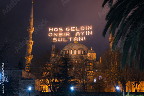 Hoş geldin ya şehri Ramazan (Translate: Welcome month of ramadan) lettering hanging on Mosque's mahya. Mahya is an enlightenment arrangement during ramadan nights between two minarets.