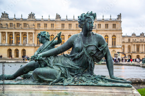 Versailles, France - Dec. 28 2022: The bronze statue in the garden of Versailles Palace in France
