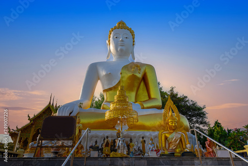 Big Buddha Chiangmai Mountain thailand. Big Buddha statue situated on a mountain ridge in Chiang Mai overlooking the city and airport Lovely background Sky © Elias Bitar