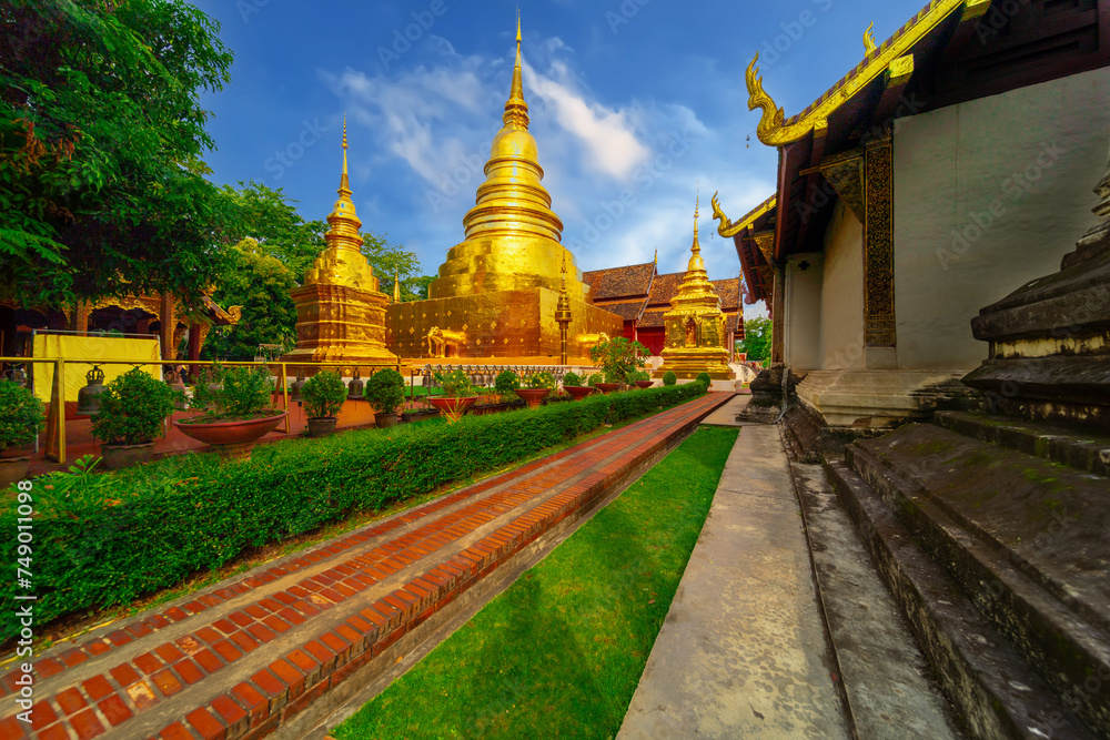 Fototapeta premium Beautiful Wat Buddhist temples in Chiangmai Chiang mai Thailand. Decorated in beautiful ornate colours of red and Gold and Blue. Lovely sunset