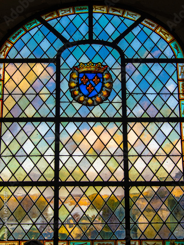 Amboise, France - Dec. 30 2022: The beautiful window with royal embleme facing the Loire valley shot from Amboise Castle in France photo