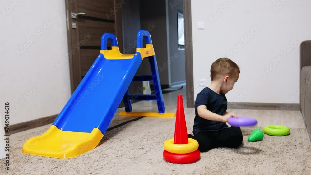Small playground indoor for boy. Toddler funny active kid playing with toys. Small playground indoor for boy. Toddler funny active kid playing with toys.