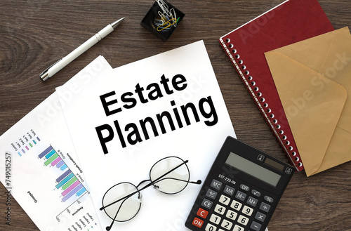 estate planning on the work desk there is a red notepad and an envelope near the calendar and calculator. text