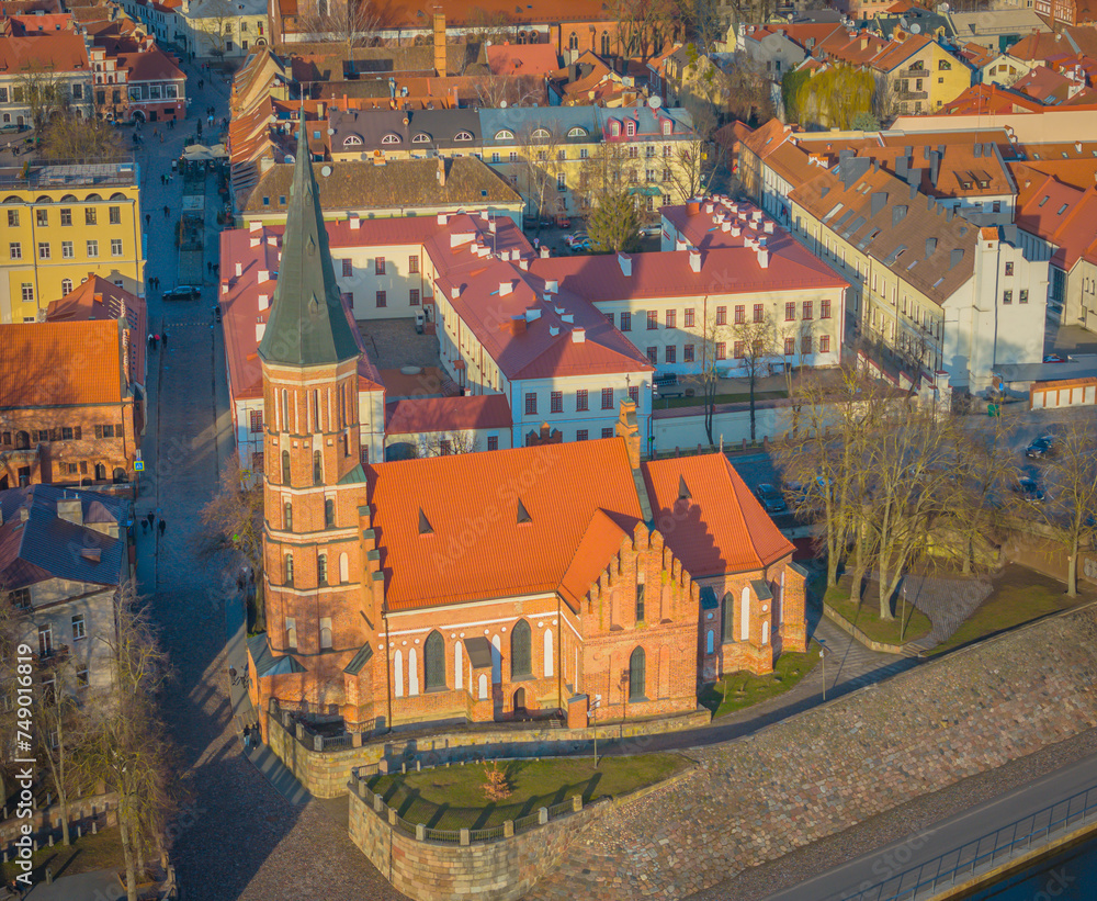 Kaunas old town, Lithuania. Drone aerial view of Kaunas city center with many old red roof houses and Vytautas Magnus church in front