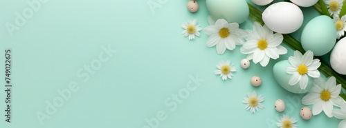 easter flowers and eggs on a light green background photo
