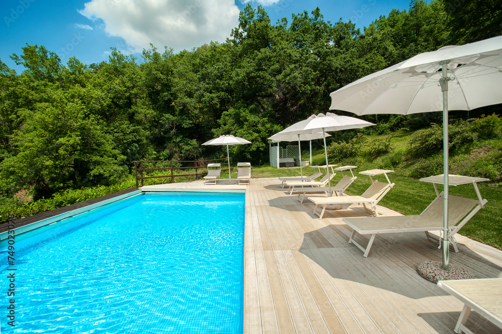 pool in country house surrounded by nature on a sunny summer day 