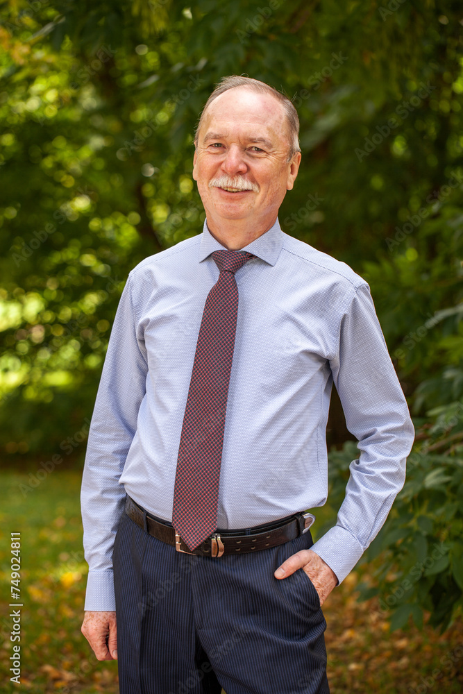 Portrait of an elderly happy man in a blue shirt Portrait of an elderly happy man in a blue shirt
