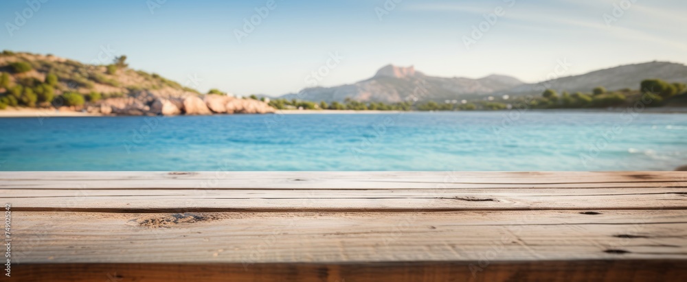 Fototapeta premium wood plank table against blurred blurred background of the beach island