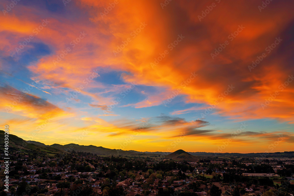 Sunset in the mountains with orange clouds, sky