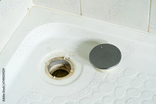 Dirty shower room. Mould in the bathroom. Dirty strongly stain on tile surface on the floor and walls shower room.