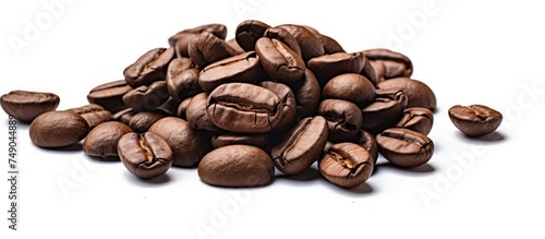 A generous heap of aromatic coffee beans is displayed on a clean white surface. The beans vary in shades of brown, promising a rich and flavorful brew. Each bean is distinct, showcasing its unique