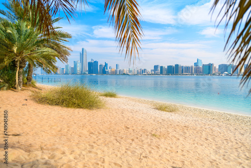 View from a sandy beach at Marina Mall island of the waterfront corniche and downtown skyline at Abu Dhabi, United Arab Emirates. © Kirk Fisher