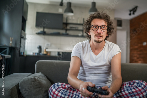 man play console video games at home hold joystick controller have fun