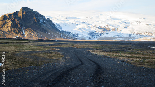 Road in South Iceland Iceland in Winter with Snow Covered Mountains at Myrdalsjökull and Blue Sky in the Background