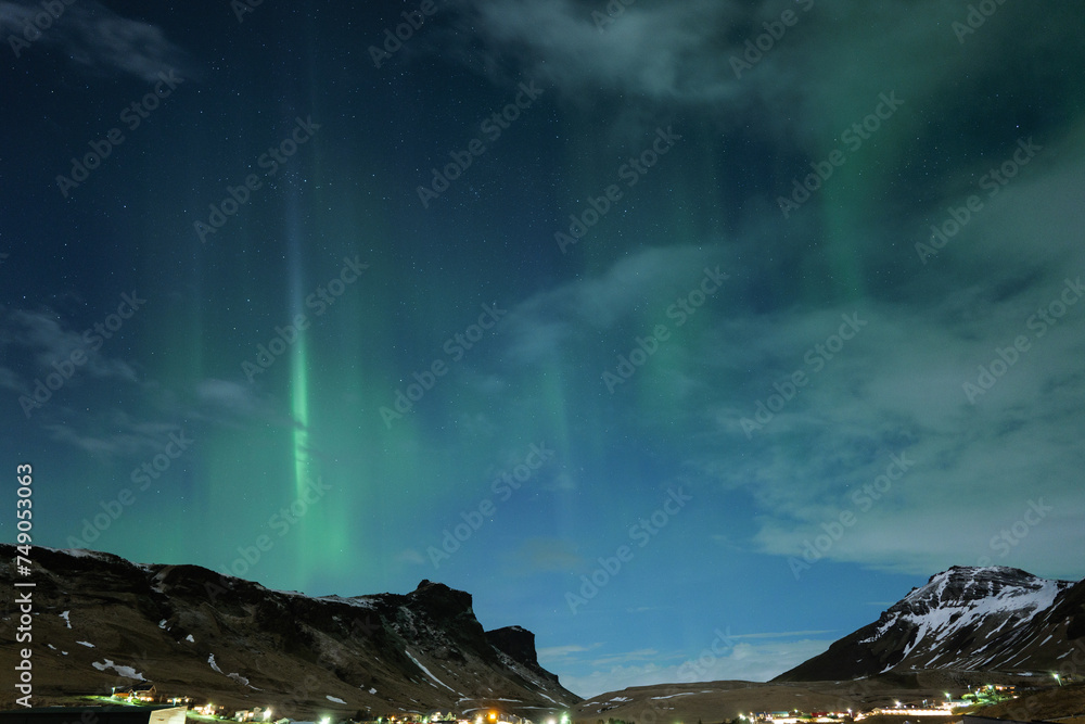 Northern Lights and Clouds in Iceland in the Winter Night Sky in Vik Northern Lights and Clouds in Iceland in the Winter Night Sky in Vik