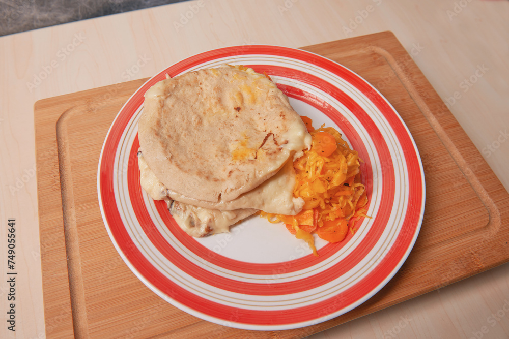 A savory trio of cheese pupusas, a staple of El Salvadoran cuisine, served with tangy curtido on a rustic platter. A savory trio of cheese pupusas, a staple of El Salvadoran cuisine, served with tangy curtido on a rustic platter.